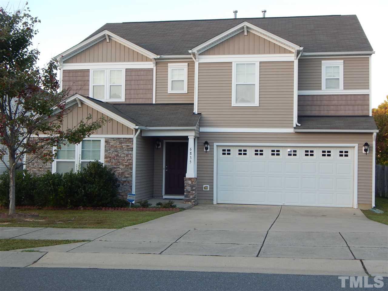 6835 Horseback Lane Raleigh, NC 27610 - Photo 1 of 25 a front view of a house with a yard and garage
