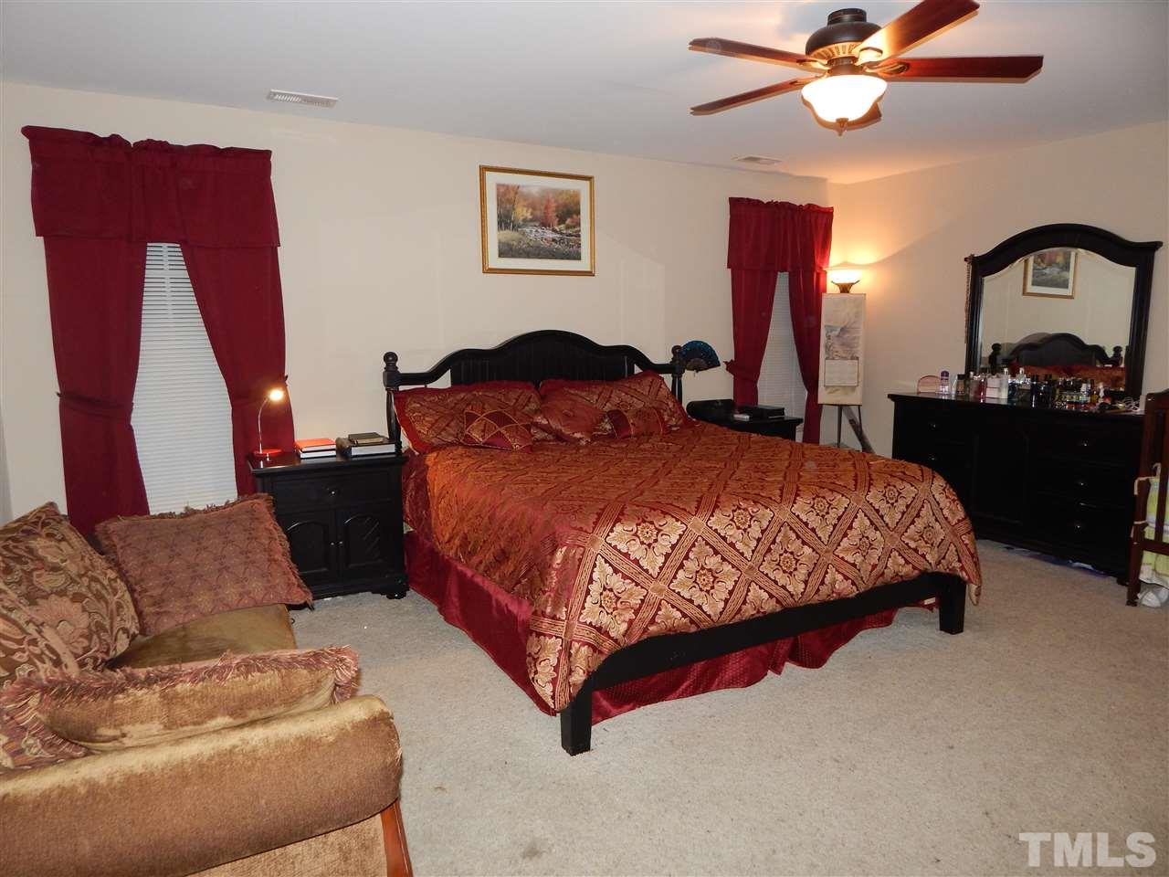 6835 Horseback Lane Raleigh, NC 27610 - Photo 13 of 25 a bedroom with a bed couch dresser and a window