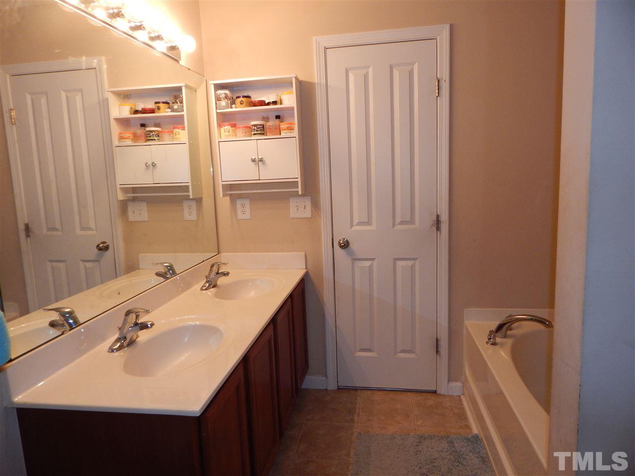 6835 Horseback Lane Raleigh, NC 27610 - Photo 14 of 25 a bathroom with a sink double vanity and a mirror