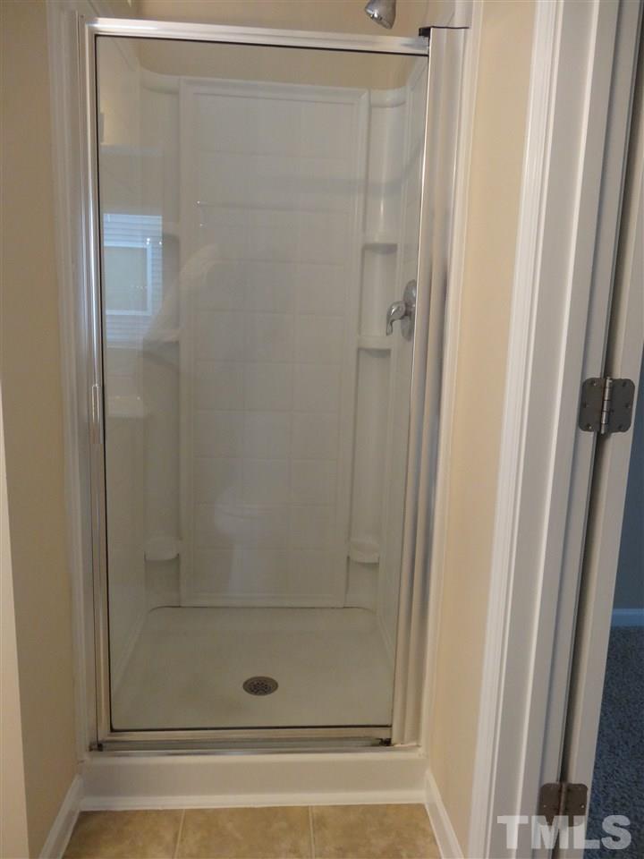 6835 Horseback Lane Raleigh, NC 27610 - Photo 16 of 25 a bathroom with a glass shower door