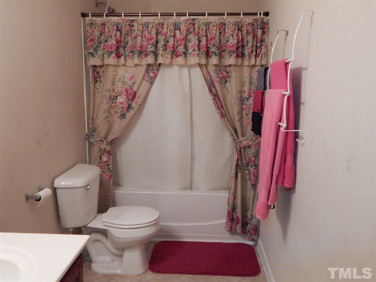 6835 Horseback Lane Raleigh, NC 27610 - Photo 20 of 25 a bathroom with a toilet and a shower curtain