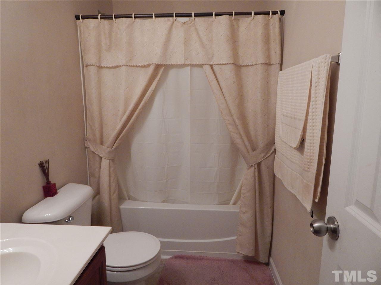 6835 Horseback Lane Raleigh, NC 27610 - Photo 21 of 25 a white toilet sitting next to a bath tub