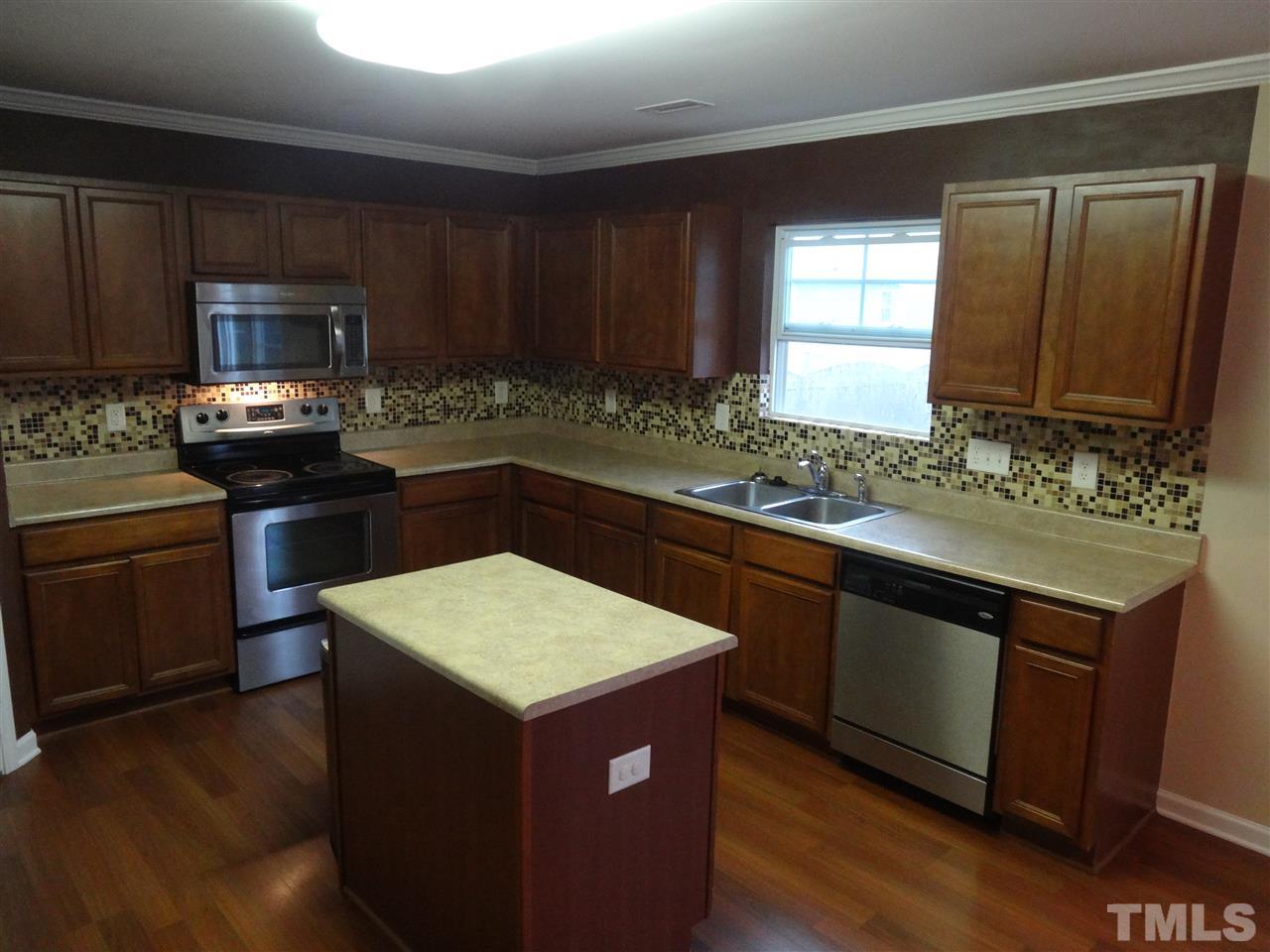 6835 Horseback Lane Raleigh, NC 27610 - Photo 5 of 25 a kitchen with a sink stove and cabinets