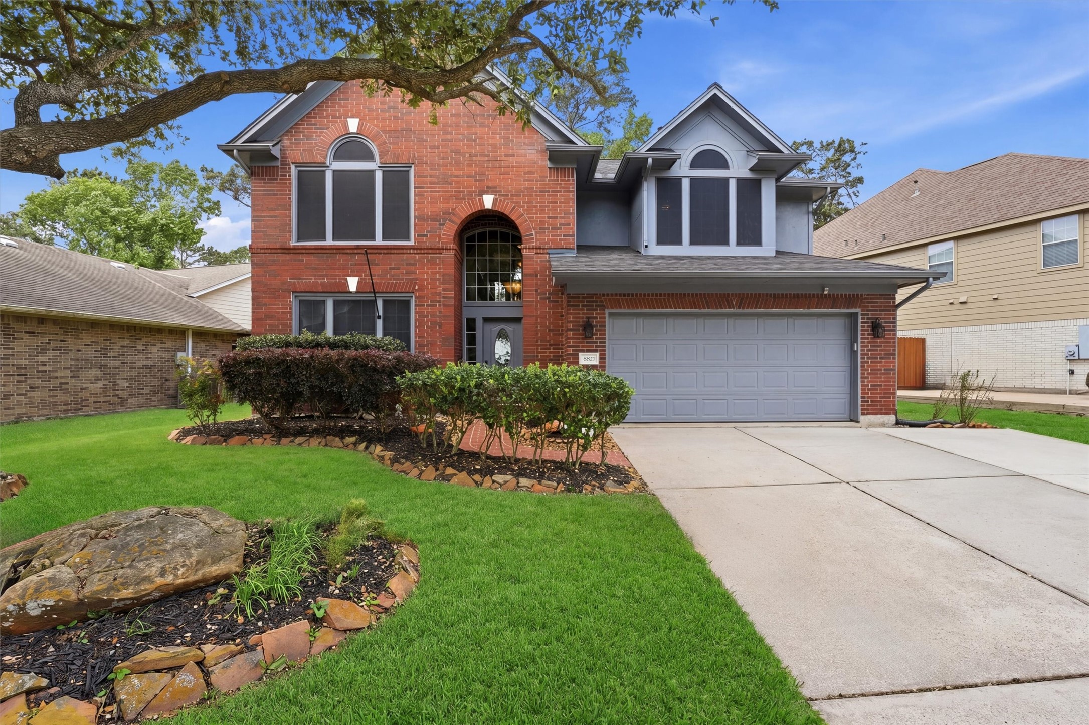 8827 Mile Run Road Humble, TX 77346 - Photo 1 of 37 a front view of a house with a yard and garage