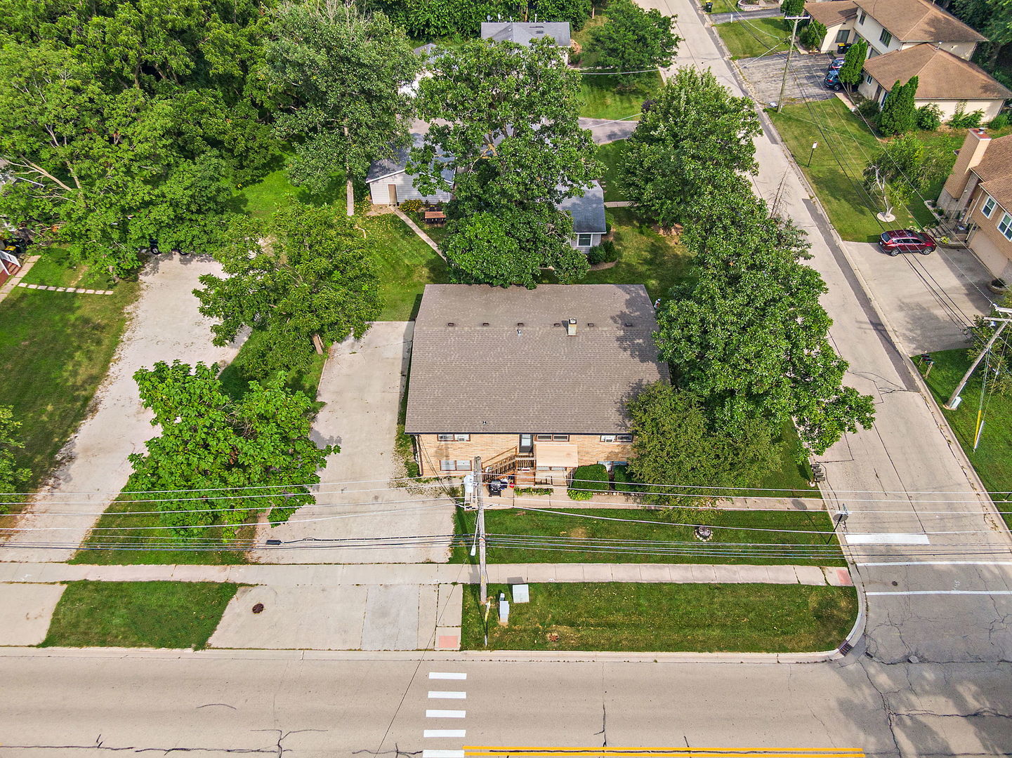 104 High Avenue, Unit C Hampshire, IL 60140 - Photo 17 of 22 an aerial view of a house with a yard and trees