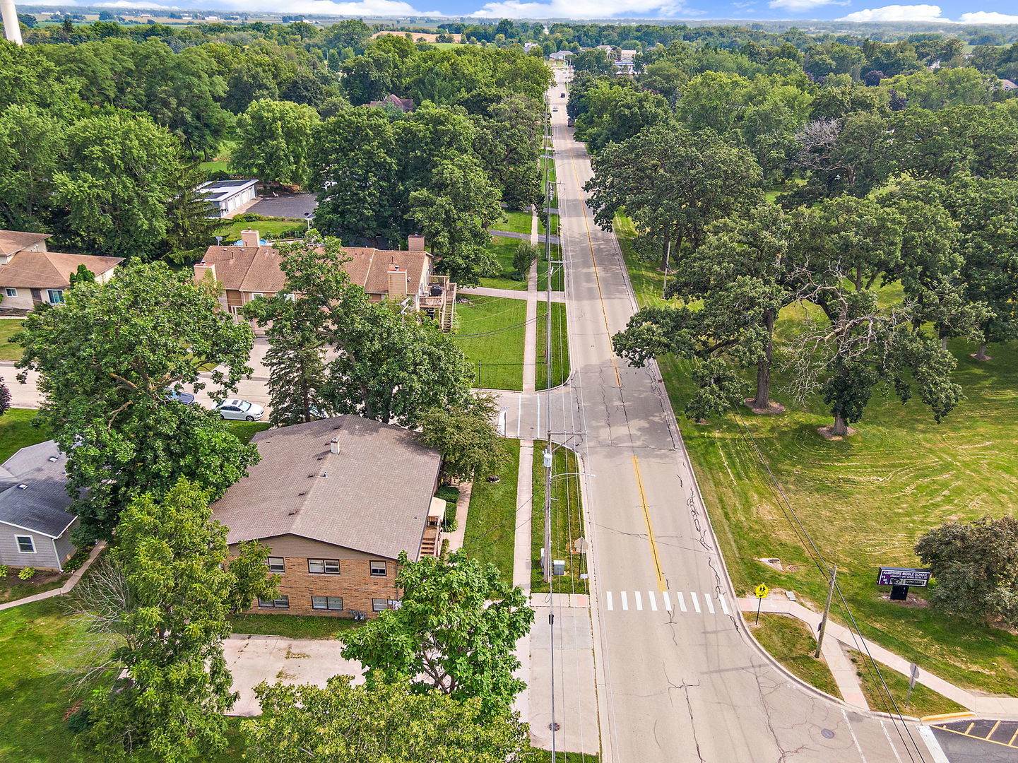 104 High Avenue, Unit C Hampshire, IL 60140 - Photo 18 of 22 an aerial view of a house with a garden and lake view