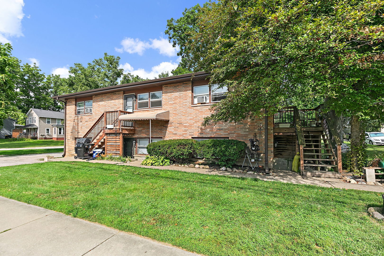 104 High Avenue, Unit C Hampshire, IL 60140 - Photo 4 of 22 a view of a house with a big yard and large trees