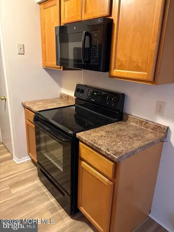 a kitchen with granite countertop a stove top oven