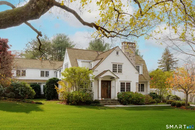 a view of a white house with a yard