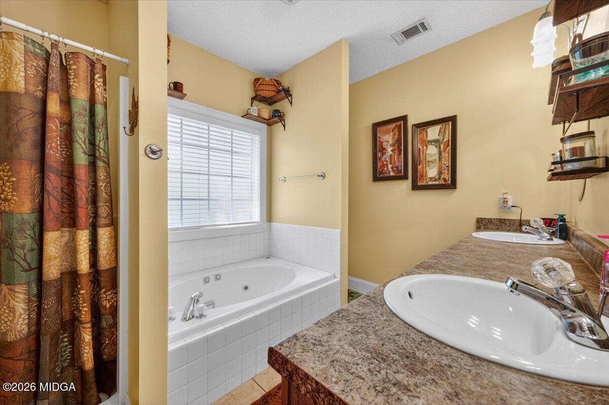 619 Grayridge Road Gray, GA 31032 - Photo 21 of 40 a bathroom with a sink and a mirror