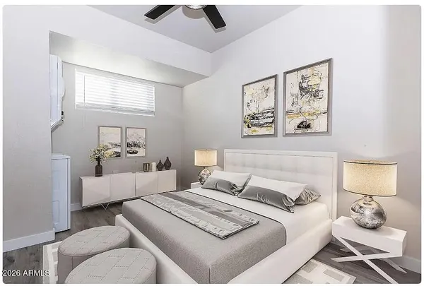 a bedroom with a bed and wooden floor