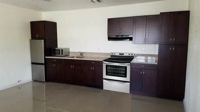 a kitchen with stainless steel appliances a refrigerator and a sink