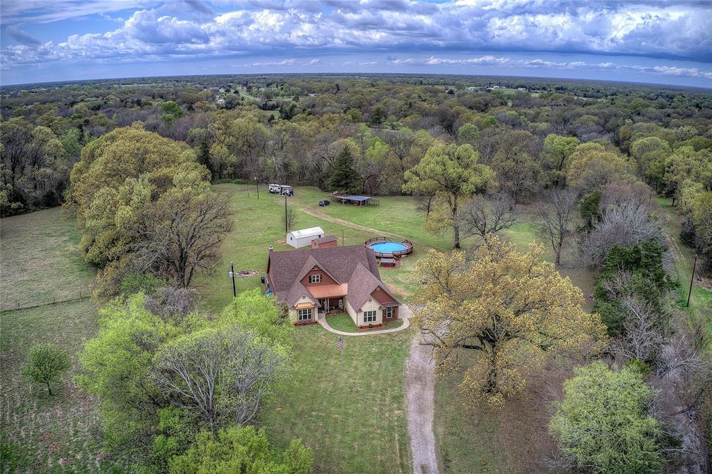 811 County Road 4250 Point, TX 75472 - Photo 3 of 37 Private country retreat with multiple storage sheds, an above-ground pool with new decking, hot tub, and a private RV hookup with its own septic and electric meter.