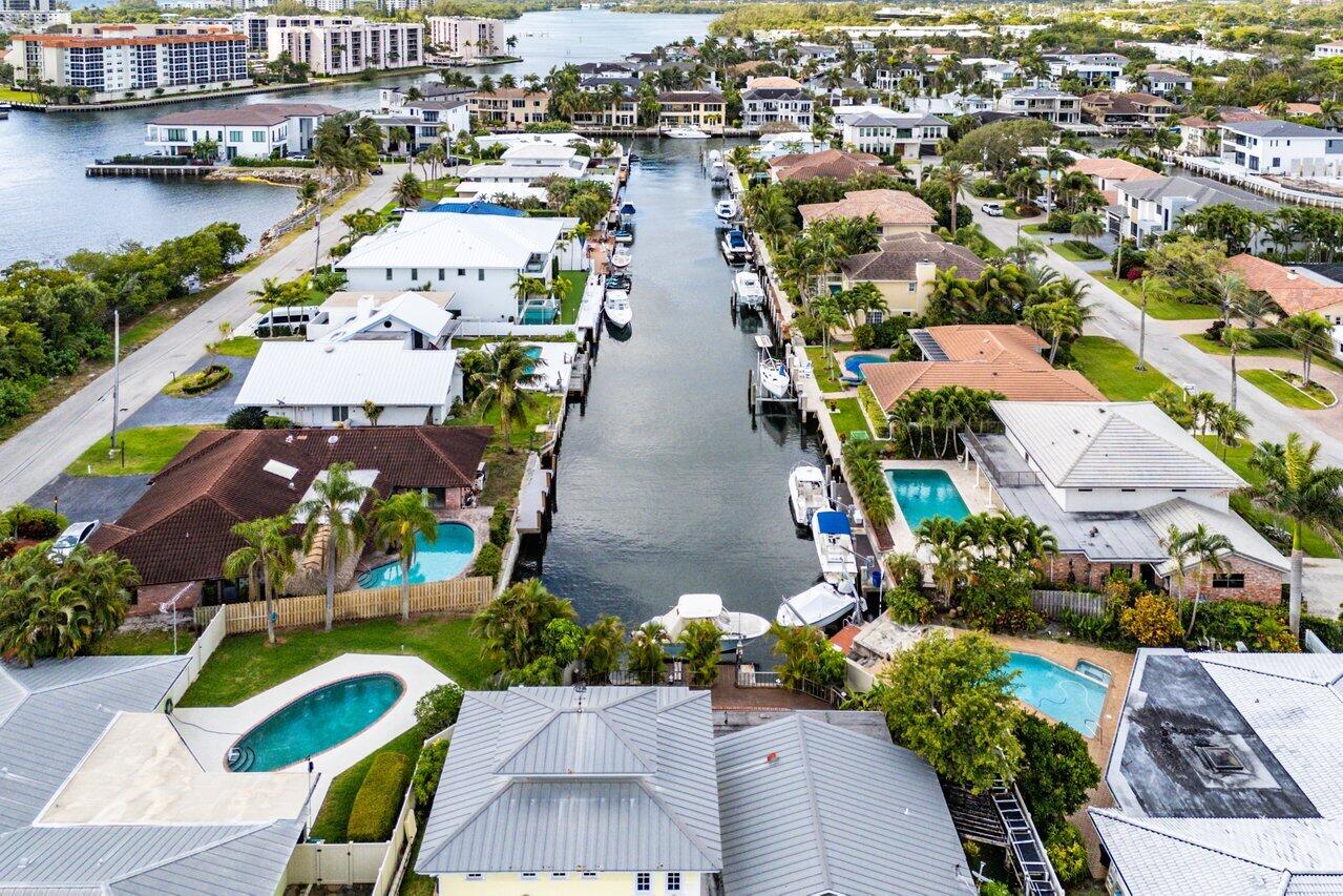 3163 Northeast 8th Avenue Boca Raton, FL 33431 - Photo 1 of 17 an aerial view of lake and residential houses with outdoor space