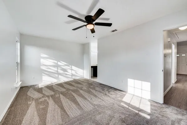 a view of empty room with ceiling fan