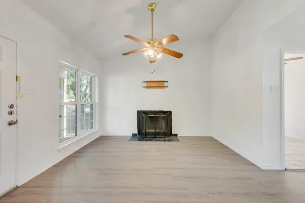 a view of an empty room with window and cabinet