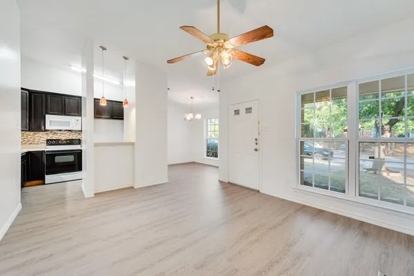 a view of kitchen with sink and refrigerator