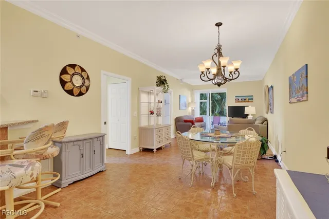a view of a dining room with furniture and chandelier