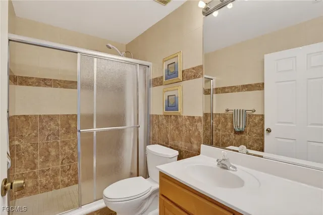 a bathroom with a sink mirror toilet and shower