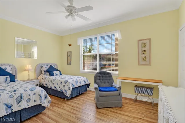 a bedroom with two beds and painting on the wall