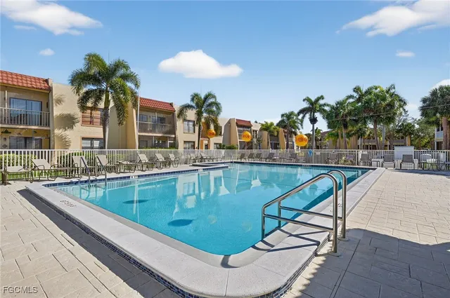 a swimming pool with outdoor seating and yard