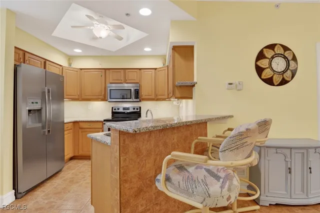 a kitchen with stainless steel appliances granite countertop a refrigerator and a stove top oven