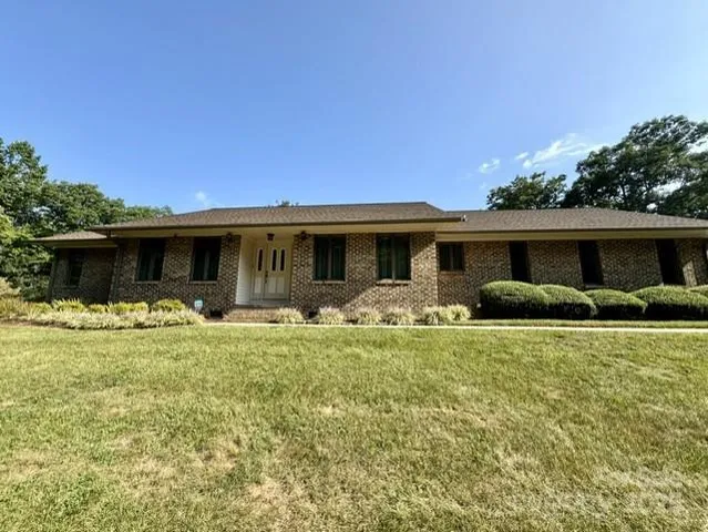 a front view of house with a garden and patio