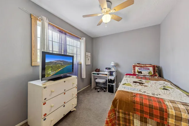 a bedroom with furniture and a flat screen tv