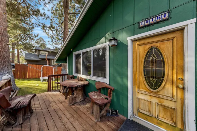 a view of a chairs and table in the balcony with a barbeque