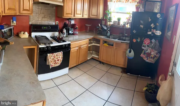 a kitchen with a sink a stove and cabinets