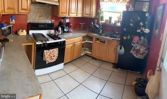 a kitchen with a sink a stove and cabinets