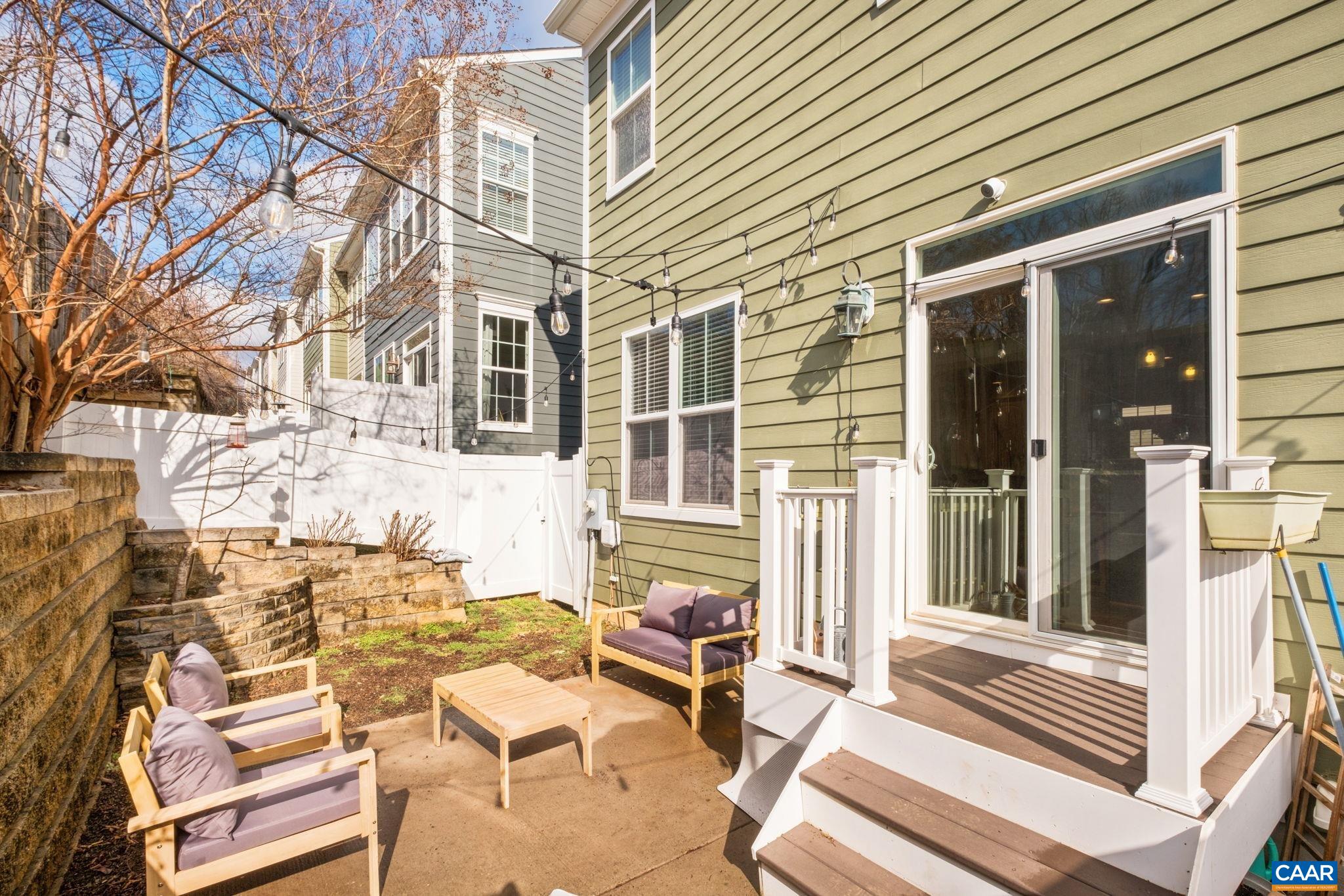 2138 Avinity Loop Charlottesville, VA 22902 - Photo 17 of 49 a view of a patio with a table and chairs and floor to ceiling window
