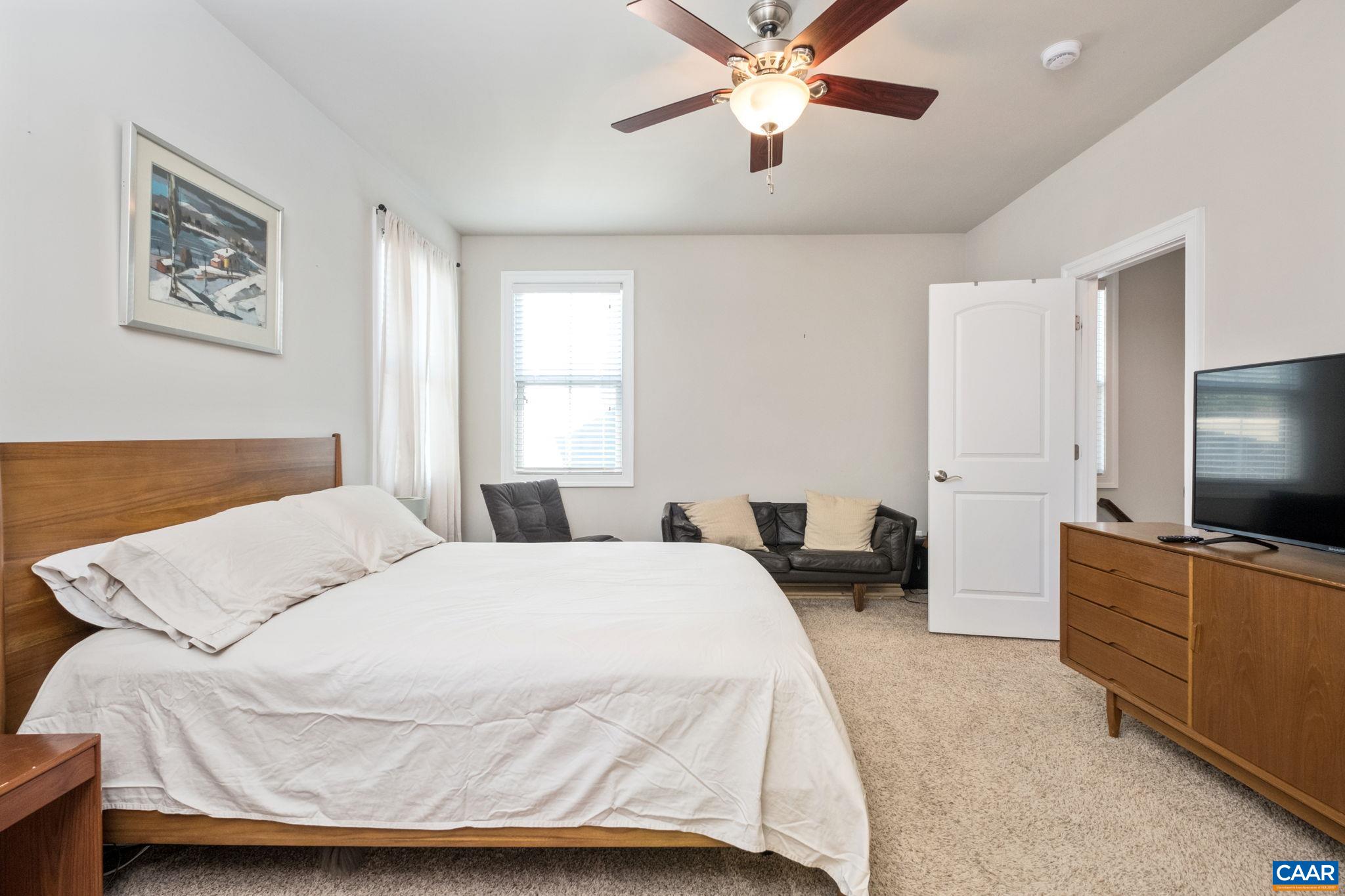 2138 Avinity Loop Charlottesville, VA 22902 - Photo 22 of 49 a bedroom with a bed and a flat screen tv