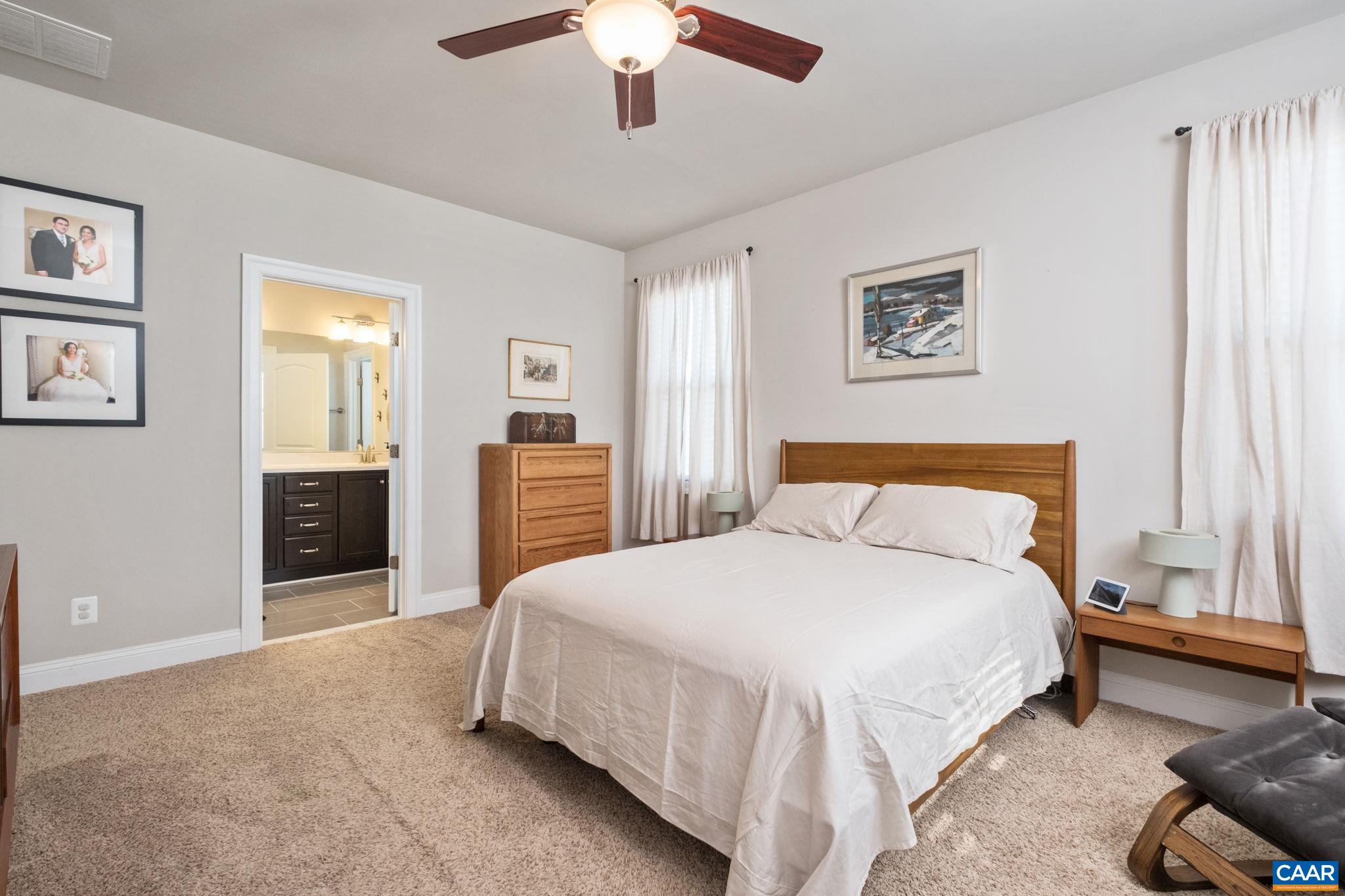 2138 Avinity Loop Charlottesville, VA 22902 - Photo 23 of 49 a bedroom with a bed and a chandelier