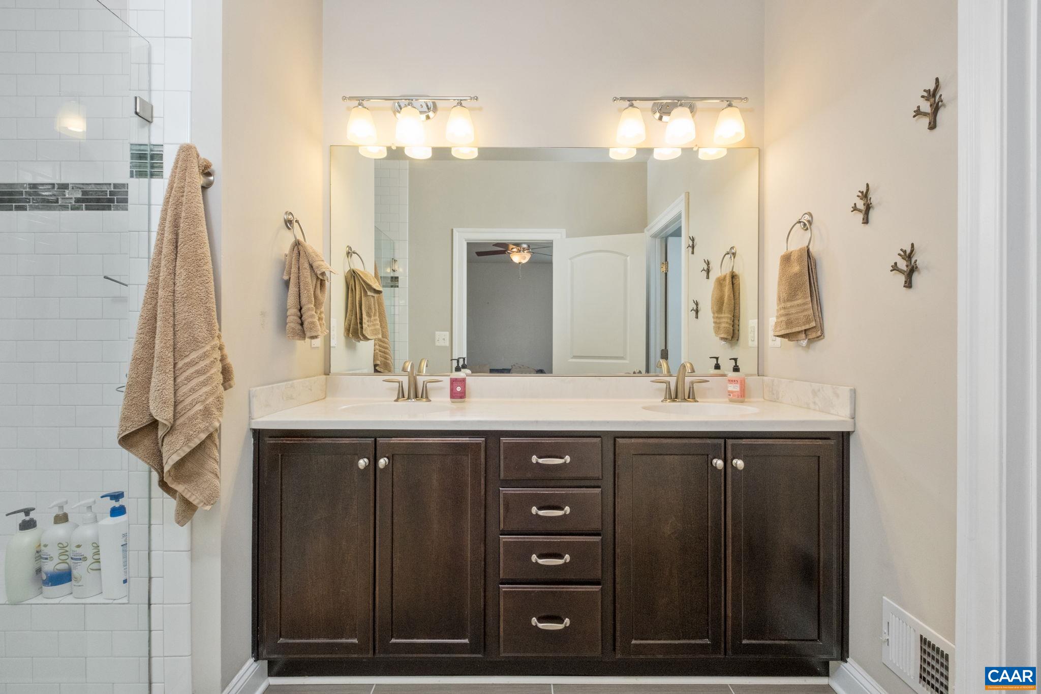 2138 Avinity Loop Charlottesville, VA 22902 - Photo 24 of 49 a bathroom with a double vanity sink and a mirror