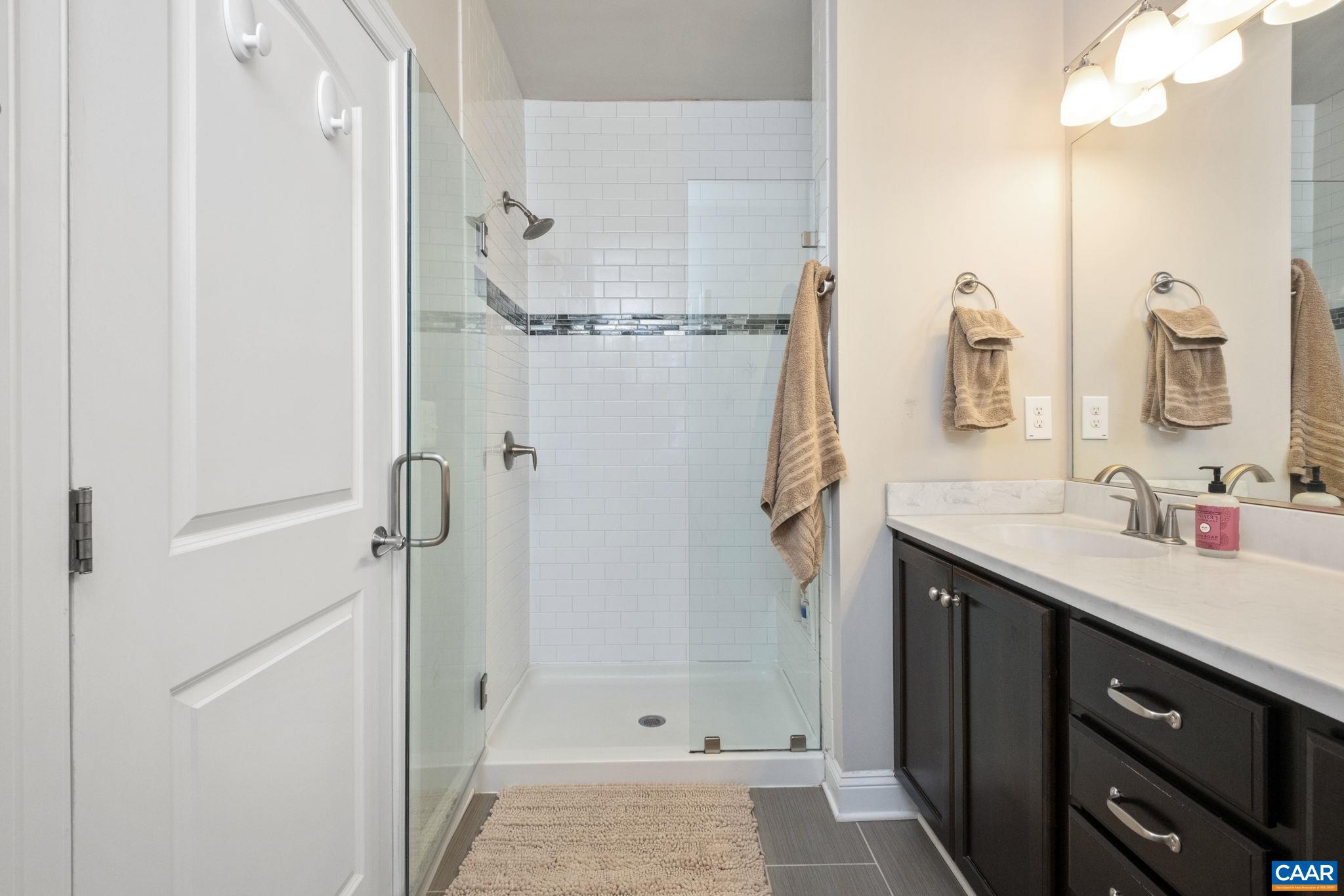 2138 Avinity Loop Charlottesville, VA 22902 - Photo 25 of 49 a bathroom with a shower sink and mirror