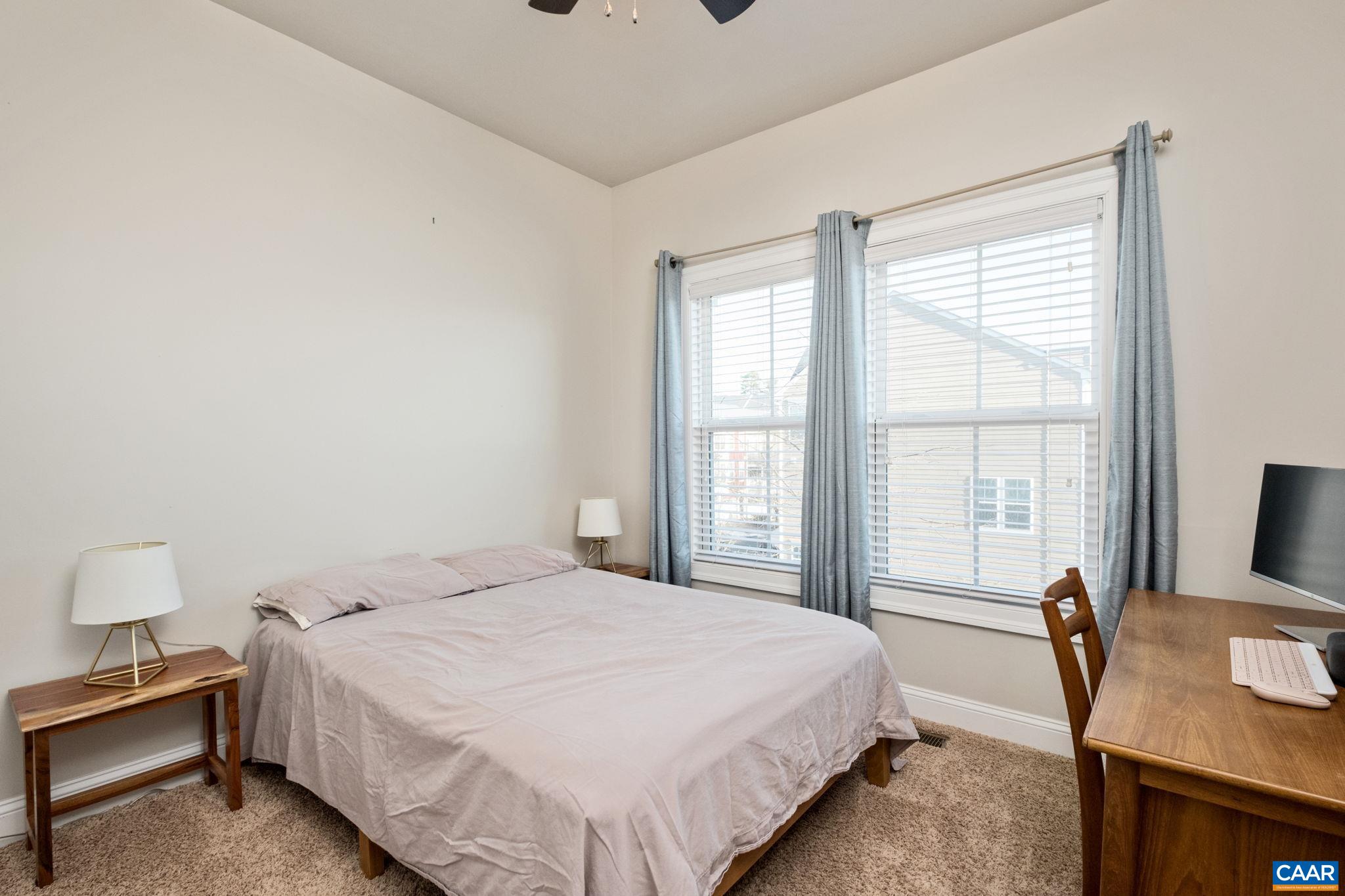 2138 Avinity Loop Charlottesville, VA 22902 - Photo 29 of 49 a bedroom with a bed and a flat screen tv