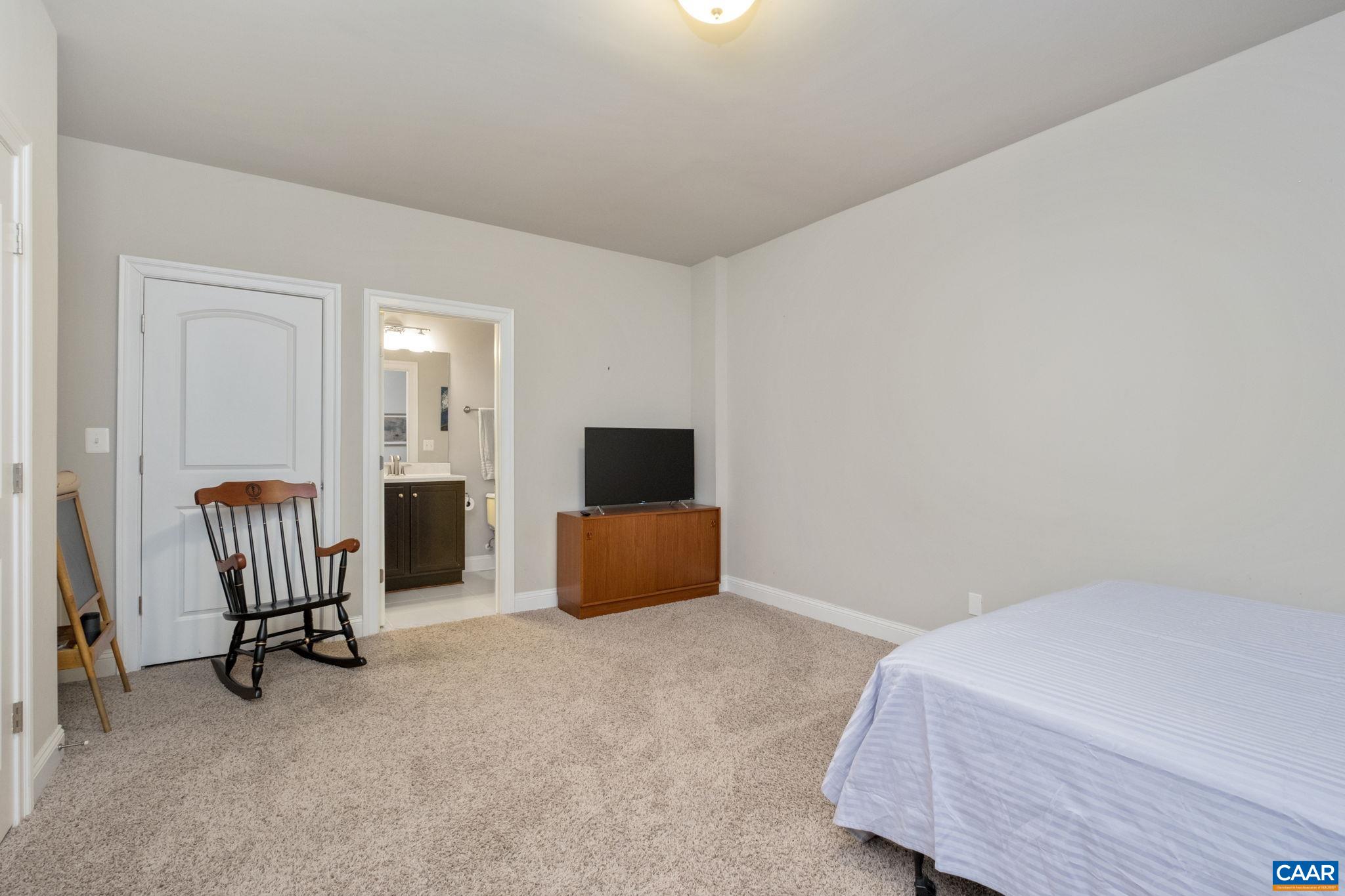 2138 Avinity Loop Charlottesville, VA 22902 - Photo 32 of 49 a bedroom with a bed and a chair
