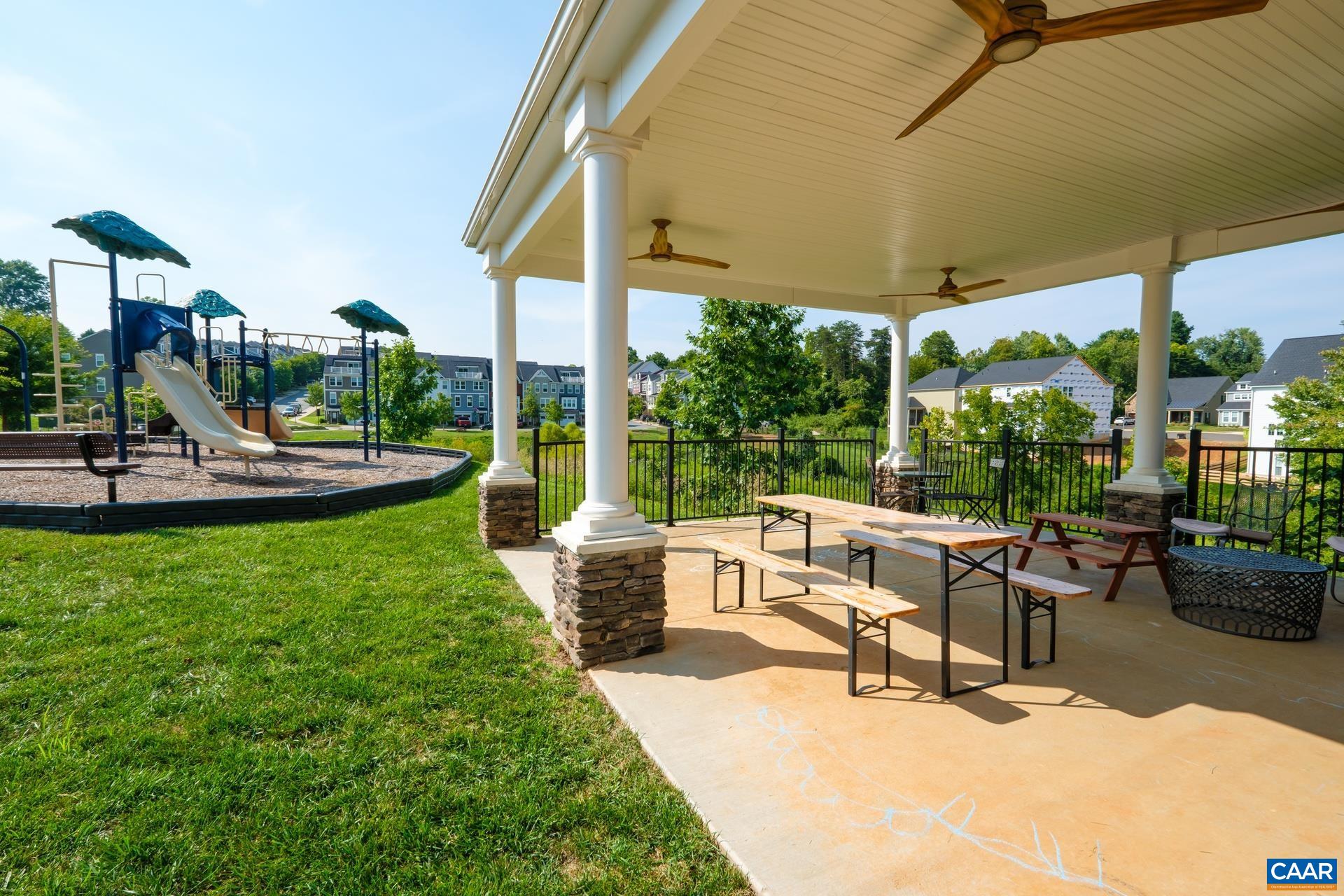 2138 Avinity Loop Charlottesville, VA 22902 - Photo 47 of 49 a view of a patio with couches and table and chairs under an umbrella