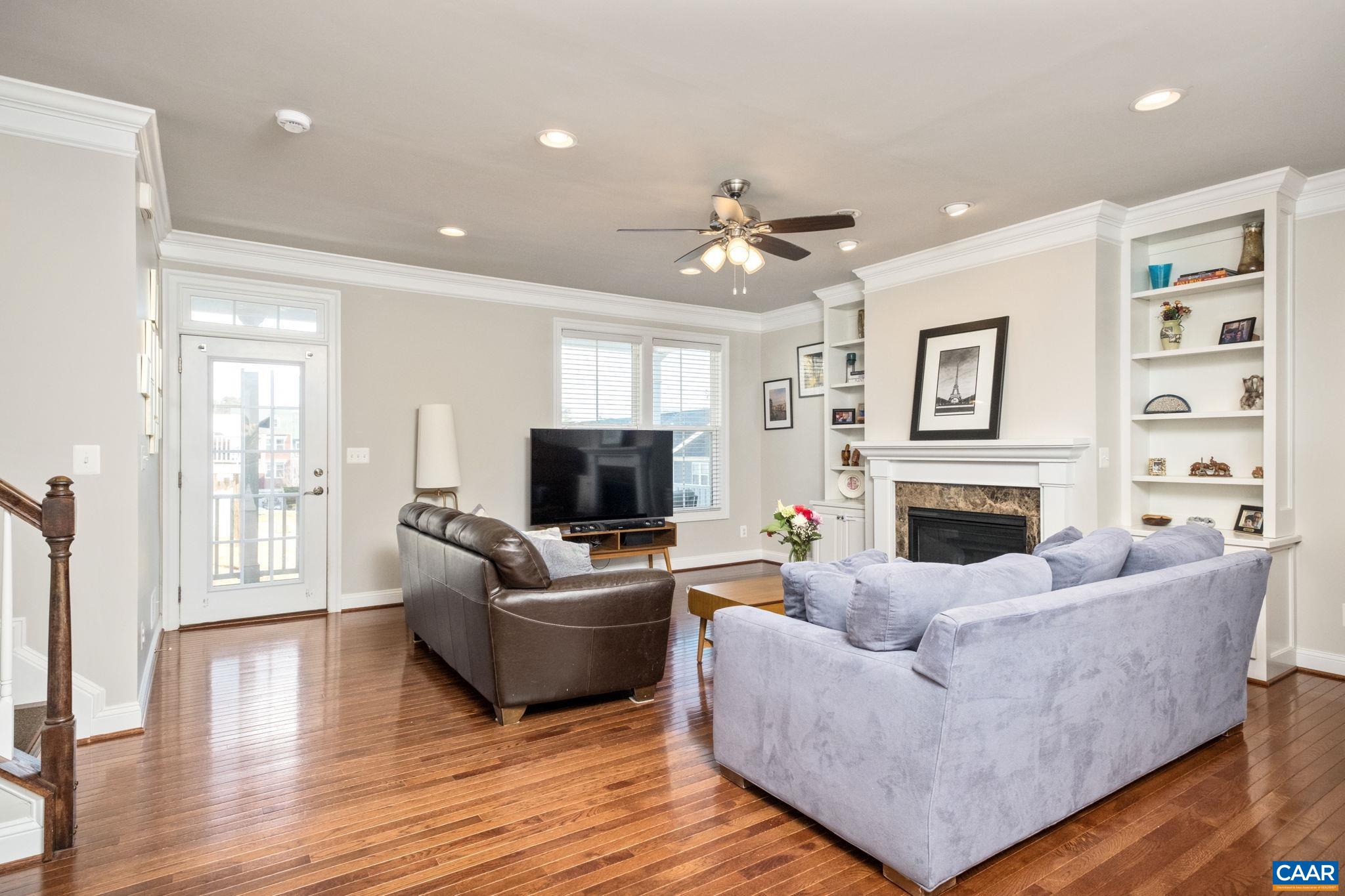 2138 Avinity Loop Charlottesville, VA 22902 - Photo 7 of 49 a living room with furniture a flat screen tv and a fireplace