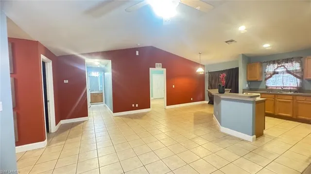 a view of kitchen and kitchen with granite countertop cabinets