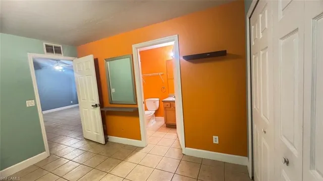 a view of a bathroom with a glass door and a walk in closet