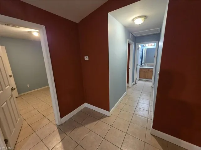 a view of hallway with a mirror and a shower