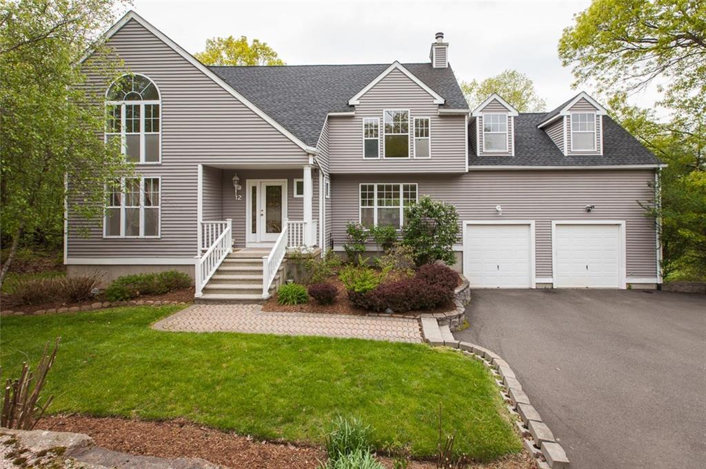 12 Pheasant Run Guilford, CT 06437 - Photo 1 of 1 a front view of a house with a yard and outdoor seating