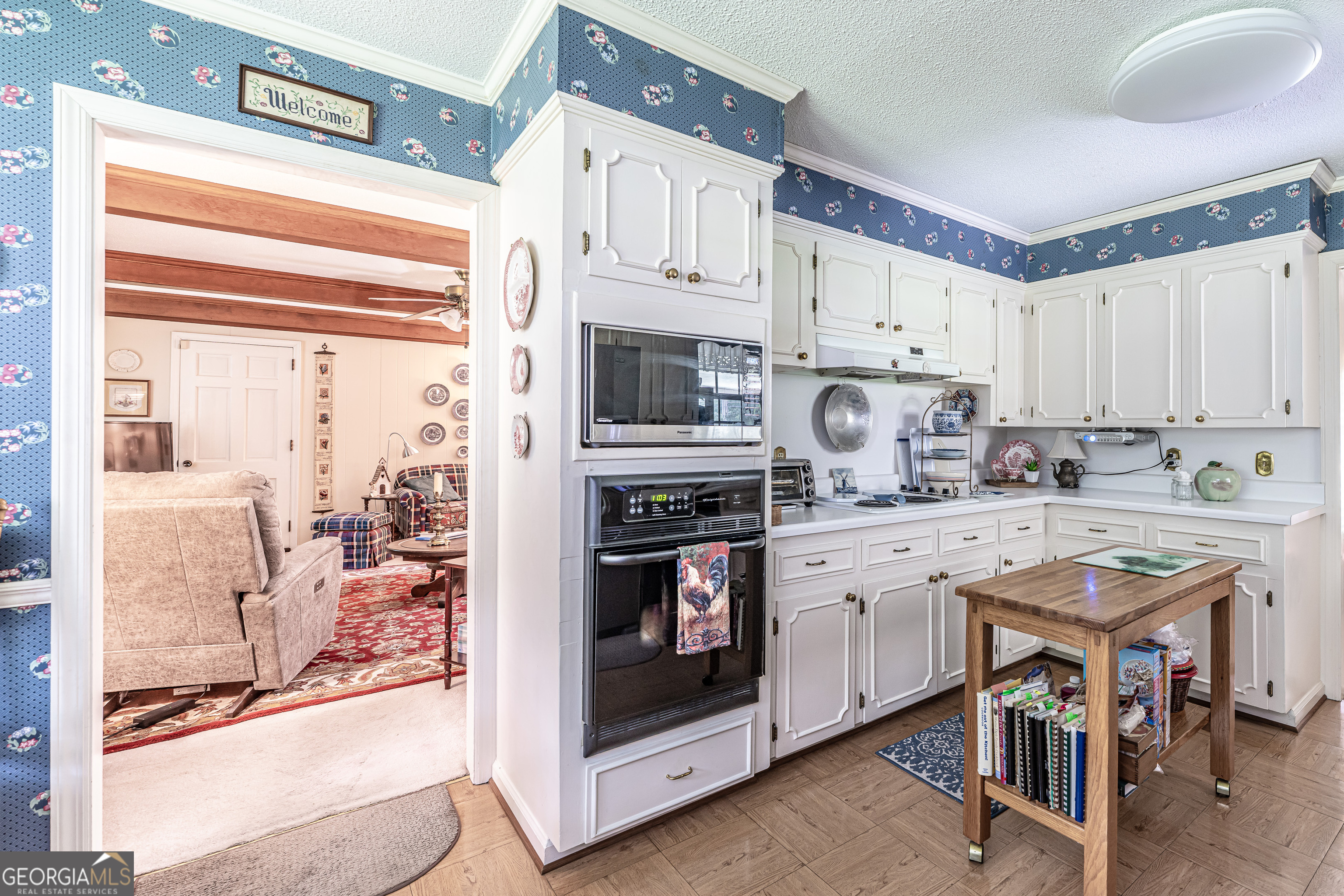 16 Cinnamon Lane Northeast Rome, GA 30161 - Photo 7 of 23 a kitchen with stainless steel appliances granite countertop a stove and white cabinets