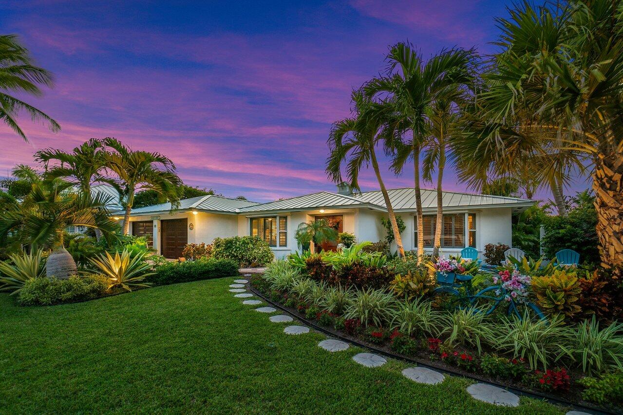 a front view of a house with a garden
