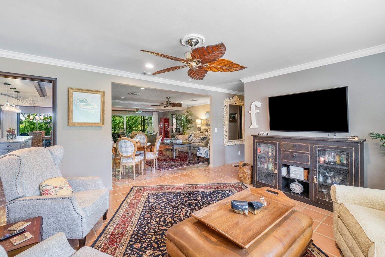 33 Ocean Drive Jupiter Inlet Colony, FL 33469 - Photo 12 of 30 a living room with furniture and a flat screen tv