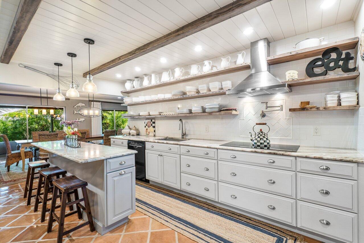 33 Ocean Drive Jupiter Inlet Colony, FL 33469 - Photo 18 of 30 a kitchen with white cabinets and sink