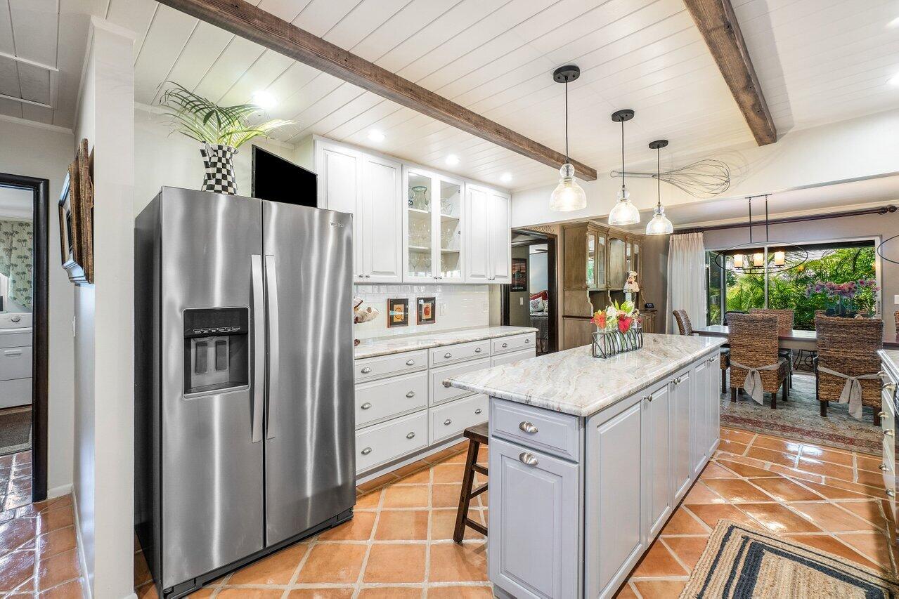 33 Ocean Drive Jupiter Inlet Colony, FL 33469 - Photo 19 of 30 a kitchen with stainless steel appliances a stove a refrigerator and a kitchen island