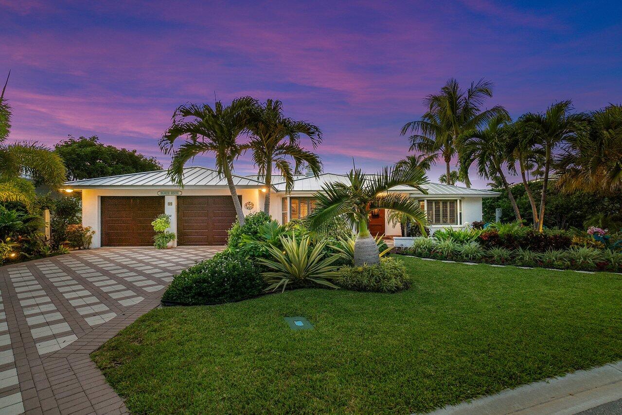 33 Ocean Drive Jupiter Inlet Colony, FL 33469 - Photo 2 of 30 a front view of a house with a garden and yard